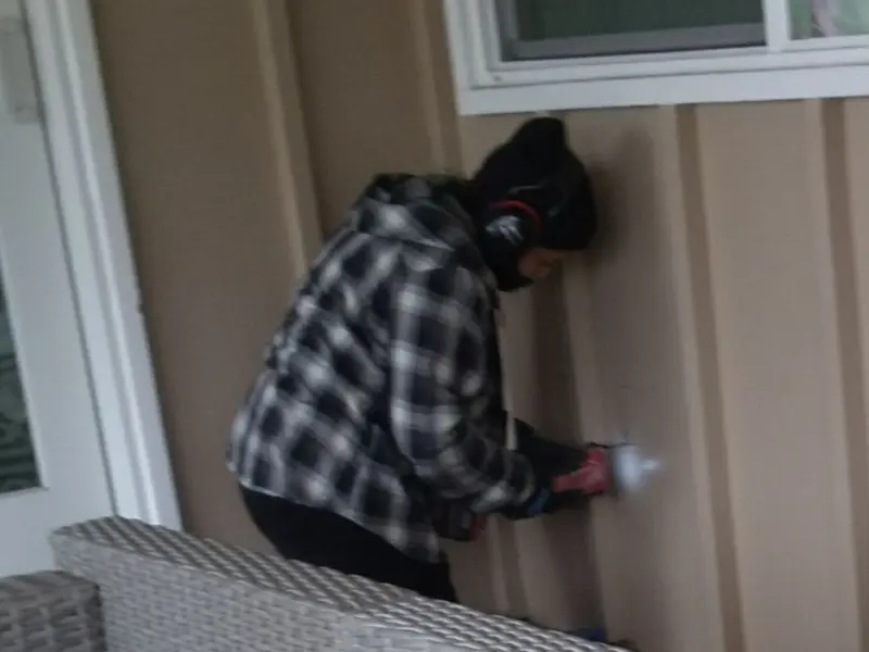 Professional electrician installing an exterior outlet in New Milford